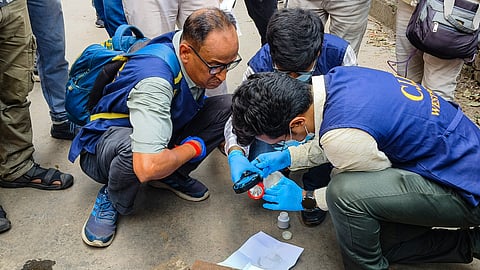 Criminal Investigation Department (CID) officials investigate the crime scene following the killing of BJP leader Suvendu Adhikari's close aide Chandranath Rath, at Madhyamgram, in North 24 Parganas district, West Bengal, Thursday, May 7, 2026.