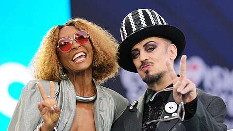 Artist Senhit from San Marino and British pop star Boy George react to fans on the signature turquoise carpet during the official start of the Eurovision Song Contest week at the town hall in Vienna, Austria, Sunday, May 10, 2026