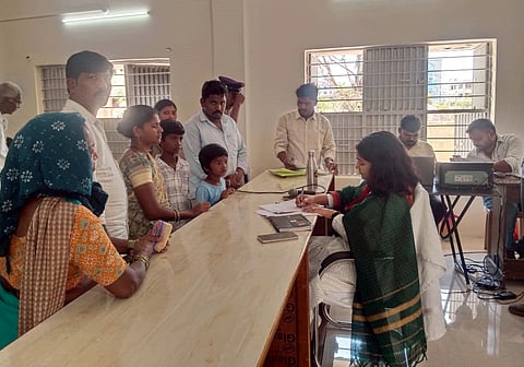 Roopa, a tribal woman along with her two children submitting a memorandum to Sub-Collector Uma Harathi against belt shops during Prajavani programme in Narayankhed on Monday