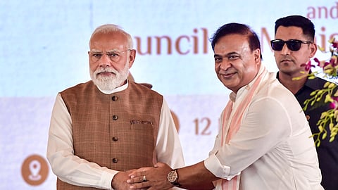 Prime Minister Narendra Modi with newly sworn-in Assam Chief Minister Himanta Biswa Sarma during the swearing-in ceremony of the state government, at Khanapara in Guwahati, Tuesday, May 12, 2026.