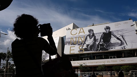 A person takes a photo outside the Palais des Festivals during preparations for the 79th international film festival, Cannes, southern France, Monday, May 11, 2026.
Photo M