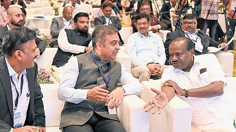 Union Minister for Heavy Industries and Steel HD Kumaraswamy in conversation with Additional Secretary to the Ministry Hanif Qureshi at the national conference on enabling EV charging infrastructure in Bengaluru on Tuesday