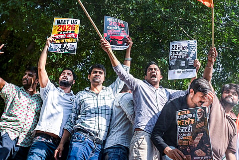 Indian Youth Congress (IYC) activists raise slogans during a protest following the alleged leak of the NEET-UG 2026 paper, in New Delhi, Wednesday, May 13, 2026.