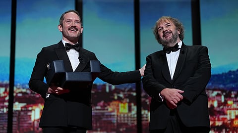Elijah Wood, left, and director Peter Jackson, recipient of the honorary Palme d'Or, pose for photographers during the opening ceremony of the 79th international film festival, Cannes, southern France, Tuesday, May 12, 2026