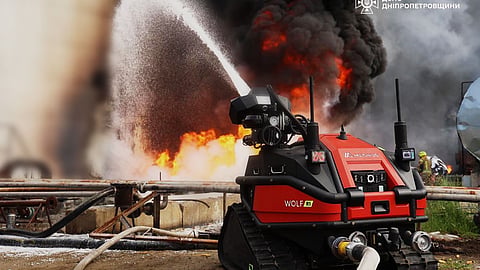 In this photo provided by the Ukrainian Emergency Service, emergency services personnel work to extinguish a fire following a Russian drone attack on a gas pipeline in Dnipropetrovsk region, Ukraine, Wednesday, May 13, 2026.