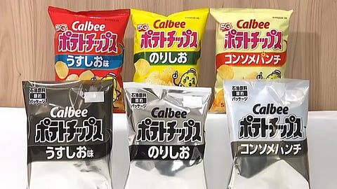 This image made from video provided by Japan’s NNN-NTV shows Calbee snack packages in color and black and white in Tokyo, Wednesday, May 13, 2026.
