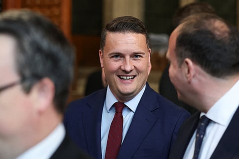 British Health Secretary Wes Streeting walks through the House of Commons to attend the State Opening of Parliament at the Palace of Westminster, London, Wednesday, May 13, 2026.