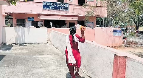 Mounika pours petrol on herself at the Wardhannapet Police Station.