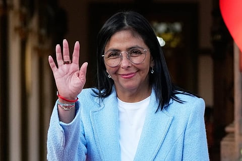 Venezuela’s acting President Delcy Rodriguez waves after bidding farewell to U.S. Energy Secretary Chris Wright following their meeting at Miraflores Palace in Caracas, Venezuela, Feb. 11, 2026.