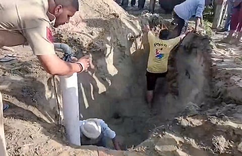 Rescue personnel carry out an operation after a child fell into a borewell, in Hoshiarpur district, Punjab.