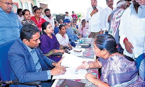 NTR District Collector G Lakshmisha takes representations from the public during the special PGRS in Mylavaram constituency on Friday