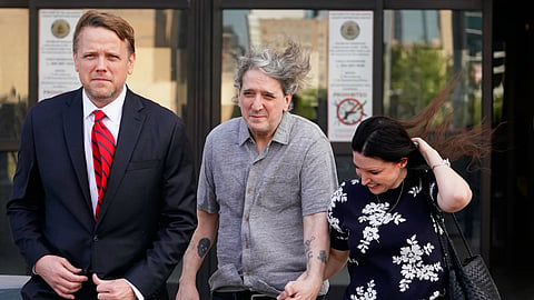 Former death row prisoner Richard Glossip, center, exits, a detention facility alongside his wife Lea Glossip, right, after being granted bond while awaiting retrial Thursday, May 14, 2026, in Oklahoma City.