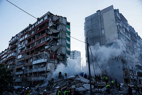 Rescue workers clear the rubble of a house heavily damaged after a Russian strike on a residential neighbourhood in Kyiv, Ukraine, on Thursday, May 14, 2026.