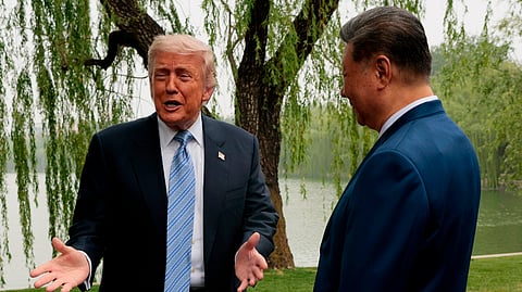 US President Donald Trump, left, speaks as he is greeted by Chinese President Xi Jinping at Zhongnanhai Garden in Beijing, China, Friday, May 15, 2026.