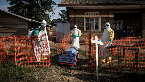 Medical workers disinfect the coffin of a deceased unconfirmed Ebola patient inside an Ebola Treatment Centre run by The Alliance for International Medical Action (ALIMA) on August 13, 2018, in Beni.