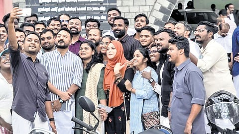 Rahul Mamkootathil posing with IUML MLA-elects and others for a selfie