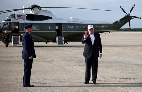 US President Donald Trump waves after stepping off Air Force One on May 15, 2026, at Joint Base Andrews, Maryland.