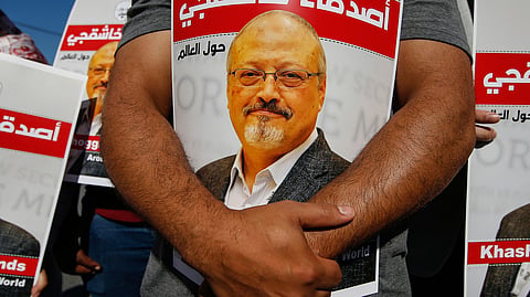 People hold posters of slain Saudi journalist Jamal Khashoggi near the Saudi Arabian consulate in Istanbul on Oct. 2, 2020.