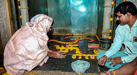 A woman decorates a floor as people gather to offer prayers inside the Bhojshala complex following the Madhya Pradesh High Court verdict declaring the site a Hindu temple dedicated to Goddess Vagdevi (Saraswati), in Dhar, Saturday, May 16, 2026.