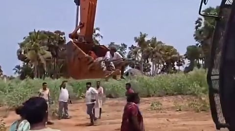 Elderly protesters staging a sit-in on a JCB bucket were moved by an excavator operator during Bhogapuram airport approach road works in Andhra Pradesh, sparking outrage after a video of the incident went viral.