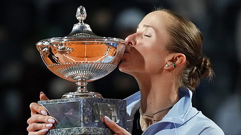 Ukraine's Elina Svitolina kisses the trophy after winning against United States' Coco Gauff at the end of the women's final match at the Italian Open tennis tournament in Rome.