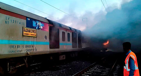 Flames and smoke billow after a fire broke out in an AC coach of the Thiruvananthapuram-Hazrat Nizamuddin Rajdhani Express in Madhya Pradesh's Ratlam district, Sunday, May 17, 2026.