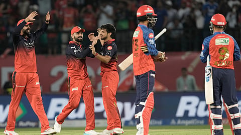 Royal Challengers Bengaluru's Virat Kohli, second left, and Rasikh Dar, center, celebrates after their team won the match against Punjab Kings during the Indian Premier League cricket match in Dharamshala, India.