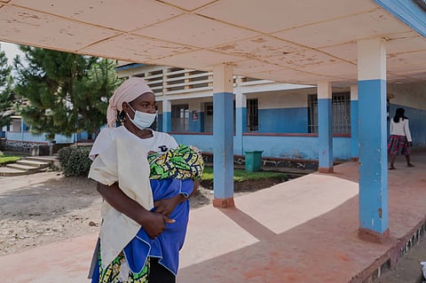A woman wearing a protective mask stands in the corridor of a hospital in Bunia, Congo, Sunday, May 17, 2026.