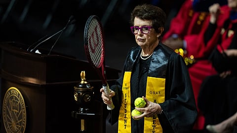 The tennis legend prepares to toss tennis balls to graduates after delivering remarks during a California State University commencement ceremony on Monday
