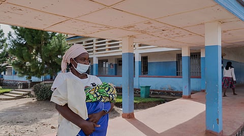 A woman wearing a protective mask stands in the corridor of a hospital in Bunia, Congo, Sunday, May 17, 2026.