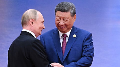 Russian President Vladimir Putin, left, and Chinese President Xi Jinping greet each other in Tianji.