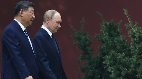 Russian President Vladimir Putin, right, speaks with Chinese President Xi Jinping during a walk at the Zhongnanhai leadership compound in Beijing, China, Sept. 2, 2025.