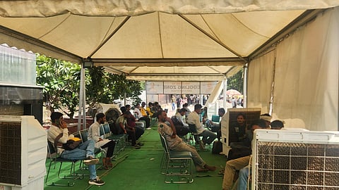 People relax and take shelter inside a cooling zone near Jama Masjid metro station on Monday afternoon.