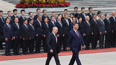 Russian President Vladimir Putin, left, walks with Chinese President Xi Jinping during a welcoming ceremony at the Great Hall of the People in Beijing Wednesday, May 20, 2026.