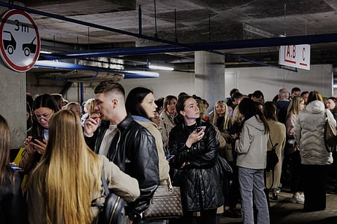 People take shelter in an underground car park during an air raid alert in Vilnius, Lithuania, Wednesday, May 20, 2026.