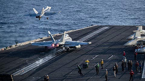 This US Navy handout photo released on May 12, 2026, by US Central Command Public Affairs shows an F/A-18E Super Hornet, attached to Strike Fighter Squadron 151, and an EA-18G Growler, attached to Electronic Attack Squadron 133, launching from the flight deck of Nimitz-class aircraft carrier USS Abraham Lincoln on May 9, 2026.