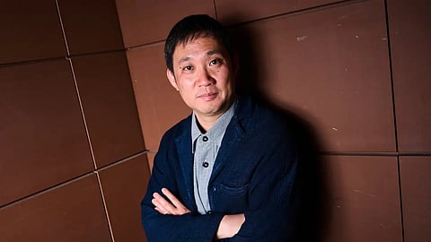 Director Ryusuke Hamaguchi poses for portrait photographs for the film 'All of a Sudden' during the 79th international film festival, Cannes, southern France, Monday, May 18, 2026.