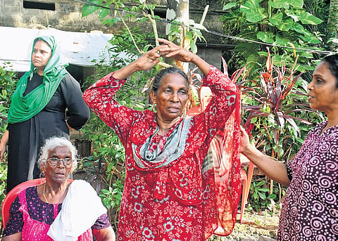 Residents of Malayidam Thuruth near Kizhakkambalam during the attempted eviction drive at Paryathkavu on Wednesday