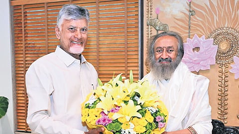 Chief Minister Nara Chandrababu Naidu greets Gurudev Ravi Shankar to mark the 45th anniversary of Art of Living Foundation in Bengaluru on Wednesday I Express
