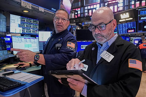 Specialist Anthony Matesic, left, and trader Fred Demarco work on the floor of the New York Stock Exchange, Friday, May 22, 2026.