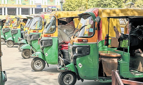 Autorickshaw drivers wait for passengers on an afternoon amid the scorching heat.