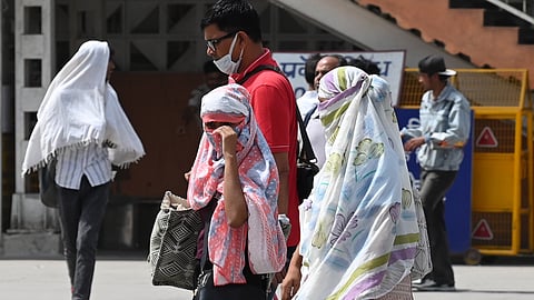 People seen out on a hot day at Ajmeri Gate, on May 21, 2026 in New Delhi.