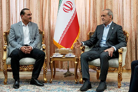Iran President Masoud Pezeshkian, right, speaks with Pakistan's Army Chief Field Marshal Gen. Asim Munir in Tehran, Iran, Saturday, May 23, 2026.