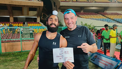 Gurindervir Singh (L) celebrates after winning the men's 100m race on Saturday