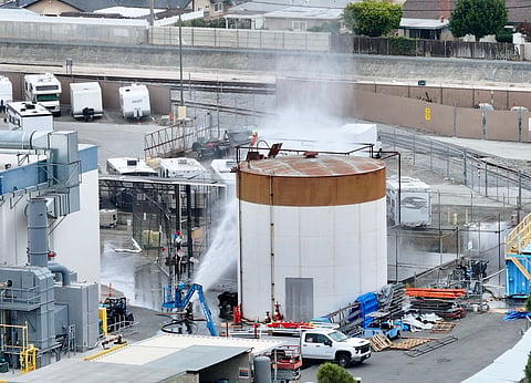 Water is sprayed on a tank that overheated at an aerospace plant in Garden Grove, Calif., Friday, May 22, 2026.