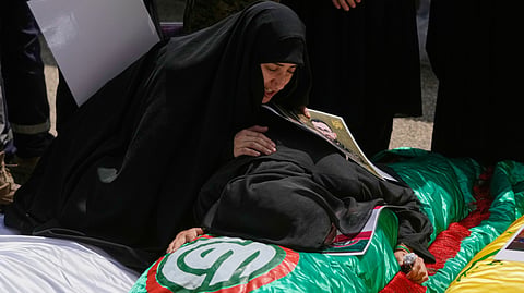 Women grieve over the bodies of relatives who were killed on Tuesday in Israeli airstrikes in the southern village of Deir Qanoun al-Nahr, ahead of their funeral procession inside a morgue in the southern port city of Tyre, Lebanon, Thursday, May 21, 2026.