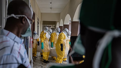 Red Cross workers prepare the body of an Ebola victim at Sofepadi Hospital for burial, in Bunia, Congo, Saturday, May 23, 2026.
