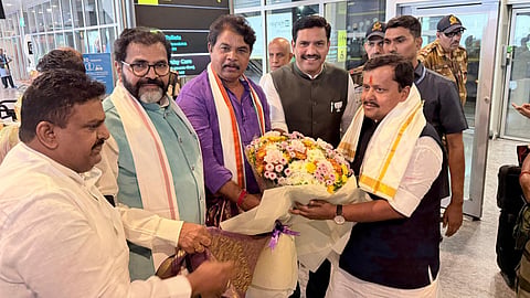 Leaders of Opposition in the Assembly and Council R Ashoka and Chalavadi Narayanaswamy and BJP state president B Y Vijayendra receive party national president Nitin Nabin at Kempegowda International Airport on Saturday.