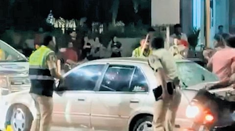 Cops try to hit glass panes of a car while attempting to intercept it on Sunday.