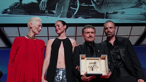 Tilda Swinton, left, poses with Renate Reinsve, Cristian Mungiu, winner of the Palme d'Or for 'Fjord' and Sebastian Stan during the awards ceremony at the 79th international film festival, Cannes, southern France, Saturday, May 23, 2026